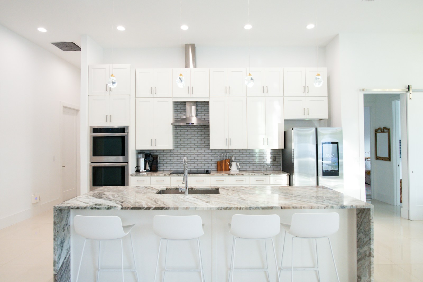 Contemporary kitchen with light countertops and cabinetry